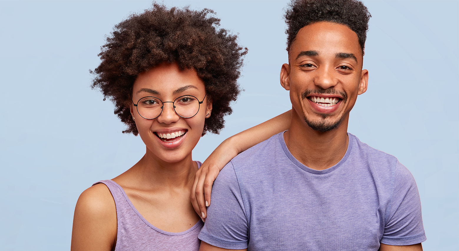 Smiling duo wearing purple shirts